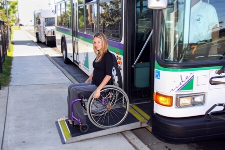 Woman in wheelchair easily accessing the bus